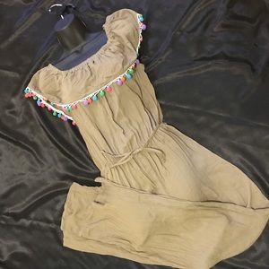 Olive green romper with pom-pom accents
